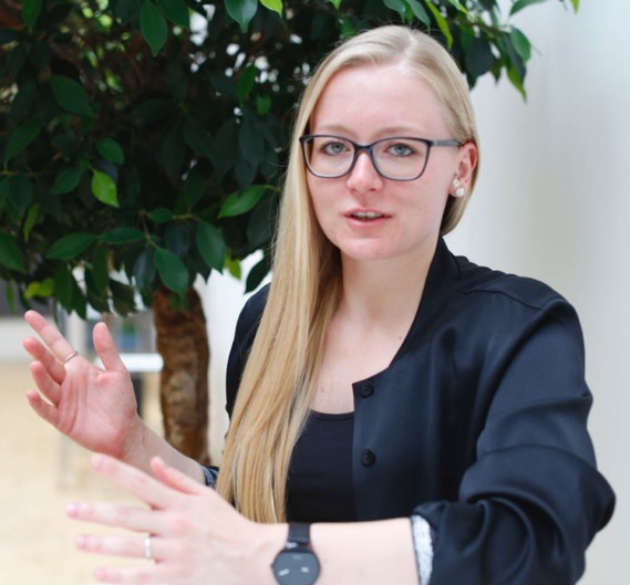 TGW Insights: Franziska erklärt im Büro in Stephanskirchen den Kartonhöhenreduzierer.