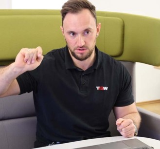 Project Manager Florian in the office in front of the laptop | TGW Insights